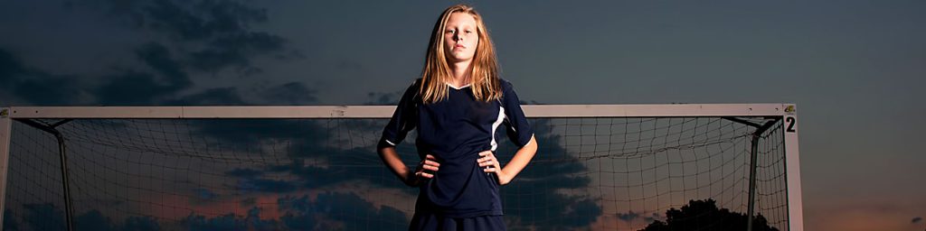 Mission Statement - girl standing in front of soccer net